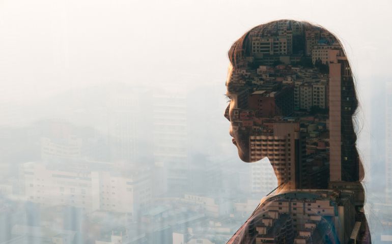double exposure of woman looking at cityscape,shenzhen,china