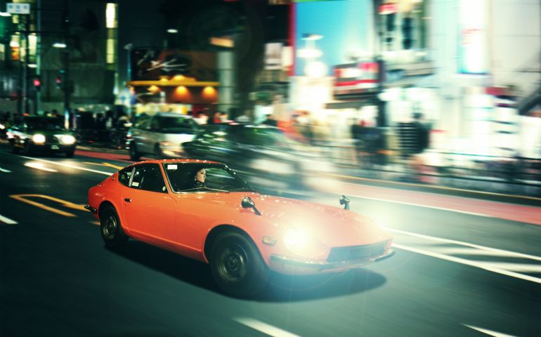Night pursuit in an oldtimer sportscar on the streets of Shinjuku, Tokyo.