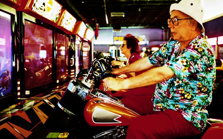 Elderly man and woman on motorcycle arcade games