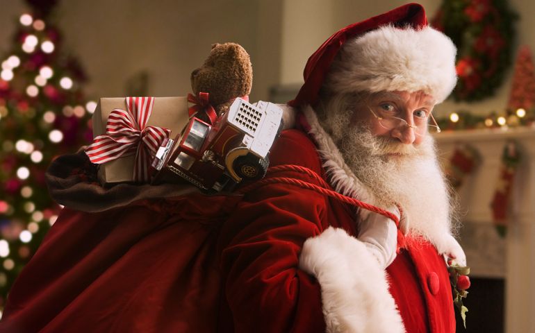 Santa Claus carrying sack of gifts, portrait, close-up