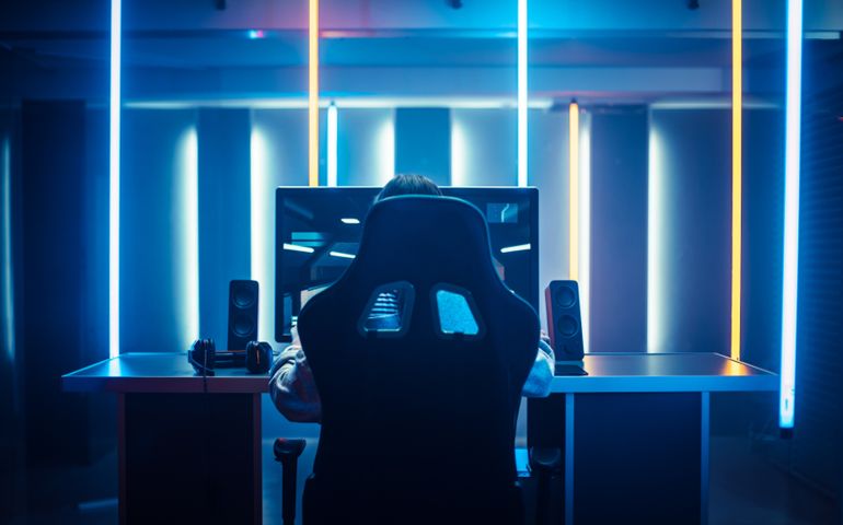 Professional Gamer Playing in First-Person Shooter Online Video Game on His Personal Computer