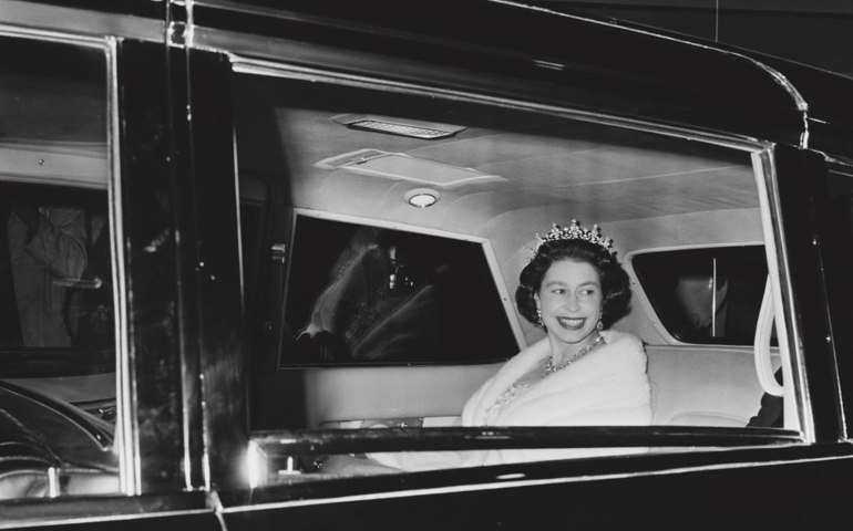 Queen Elizabeth II sitting in the backseat of a car on her way to the Confederation Centre of the Arts in Charlottetown during her visit to Canada, 6th October 1964.