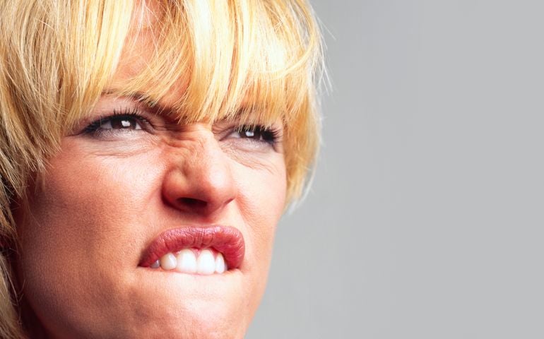 Rage filled woman mouthing the 'F' word