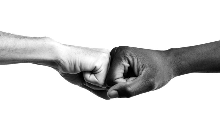 Interracial fists collide