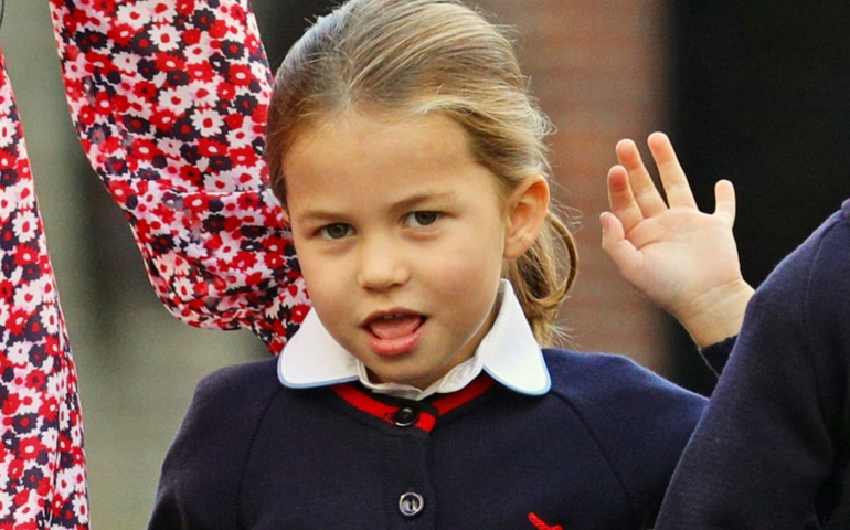 Princess Charlotte waves as she arrives for her first day of school at Thomas's Battersea in London, accompanied by her brother Prince George and her parents the Duke and Duchess of Cambridge on September 5, 2019 in London, England.