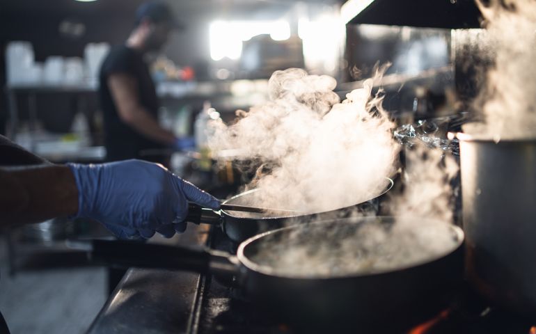 Chef in Restaurant preparing orders.