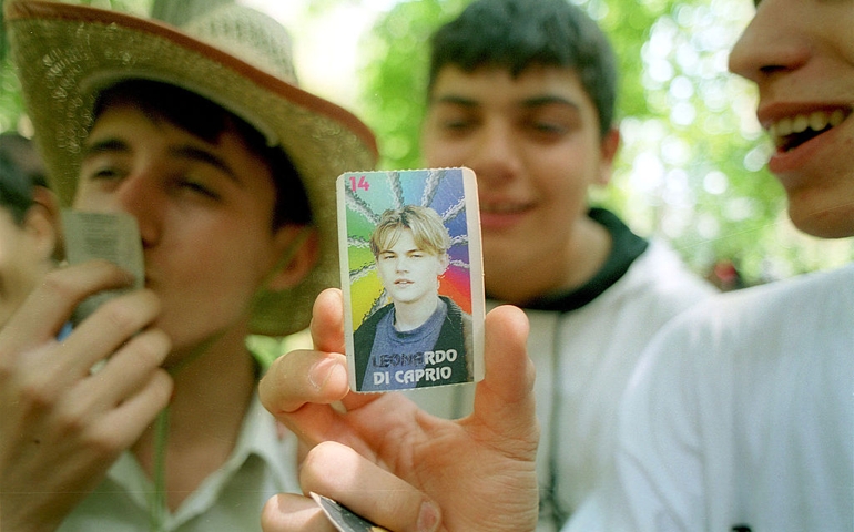 Teenagers show off their Leonardo DiCaprio collectible cards June 15, 2001 at a picnic in Darban, Iran. Although American culture is officially frowned upon in the Islamic Republic of Iran, many young people still gain access to it through satellite television.
