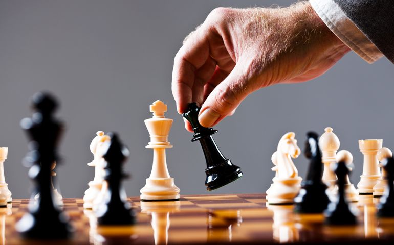 Moments before checkmate, a businessman's hand moves his queen. Chess makes for wonderful metaphors and there are lots here, including the war between the sexes. Shot with Canon EOS 1Ds Mark III.