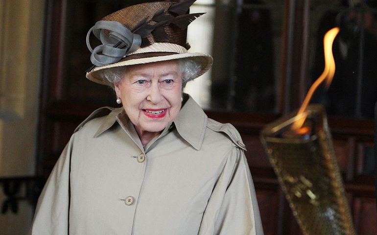 Queen Elizabeth II is shown the Olympic flame at Windsor Castle on day 53 of the London 2012 Olympic Torch Relay on July 10, 2012 in Windsor, England. The Olympic Flame is now on day 53 of a 70-day relay involving 8,000 torchbearers covering 8,000 miles.