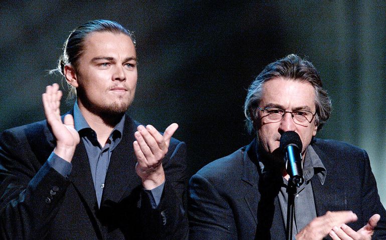 American actors Leonardo DiCaprio and Robert DeNiro speak on stage at the concert for New York City to benefit the victims of the World Trade Center disaster at Madison Square Gardens on October 20, 2001 in New York.