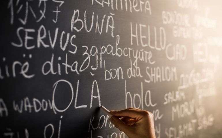 Hello in many languages written with chalk on blackboard