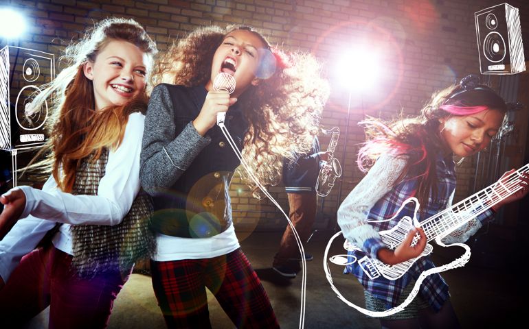 Shot of children singing and playing rock music on imaginary instruments