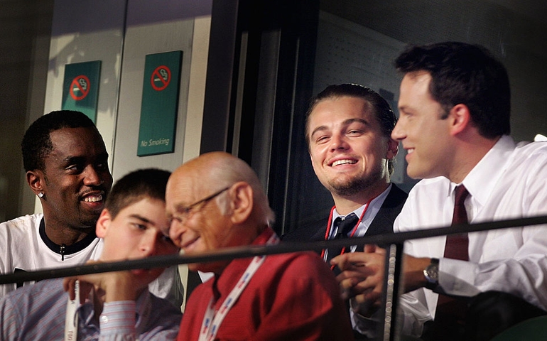 Actors Ben Affleck (R)and Leonardo DiCaprio (C), hip-hop artist Sean 'P. Diddy' Combs (L) and television producer Norman Lear (Front) observe the proceedings from a skybox at the Democratic National Convention on July 29, 2004 at the FleetCenter in Boston, Massachusetts.