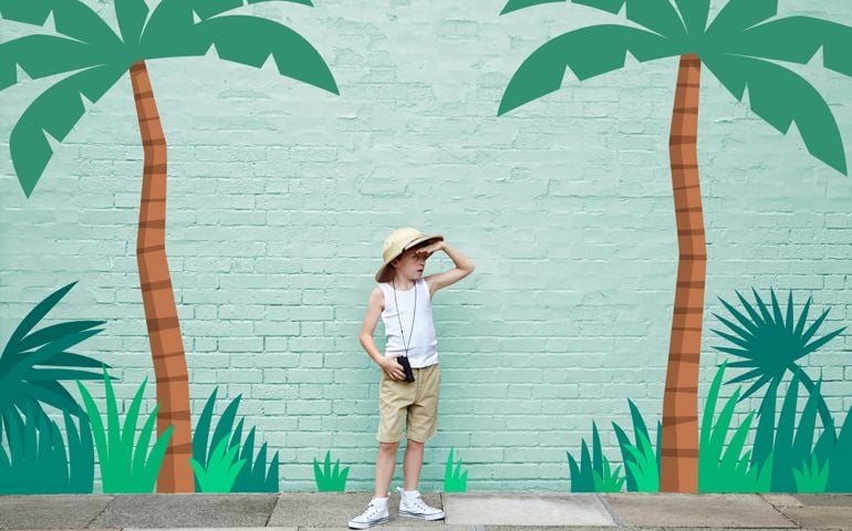 boy dressed as an adventurer with jungle scene