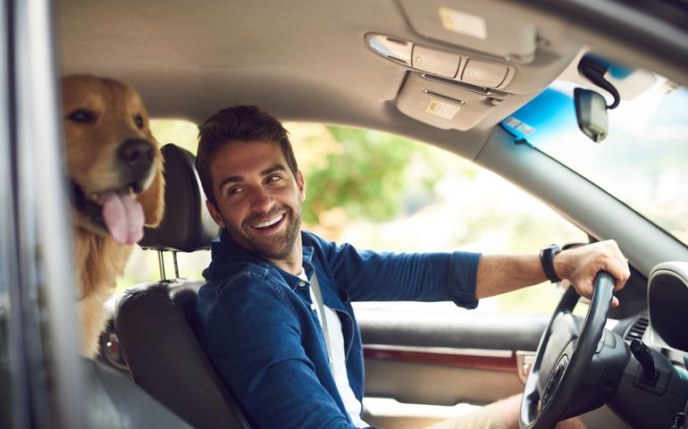 Cropped shot of a handsome young man taking a drive with his dog in the backseat