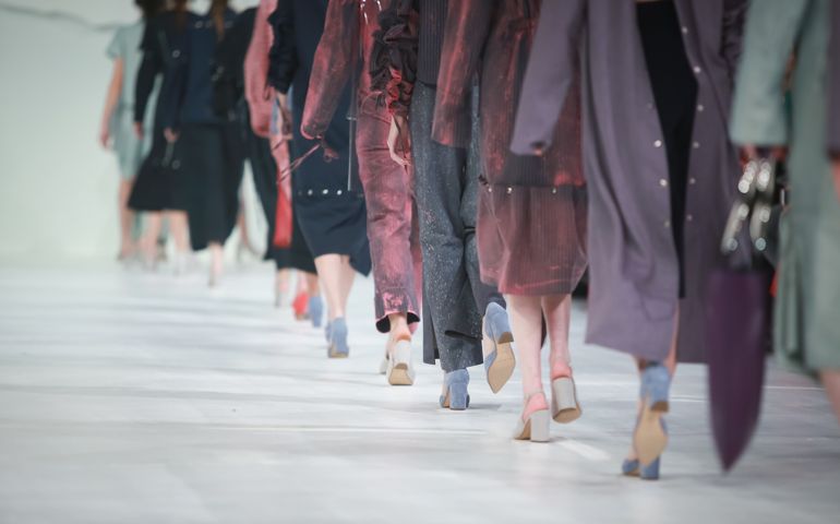 Fashion Show, Catwalk Runway Show Event. Detail of lined up rear view, fashion models.