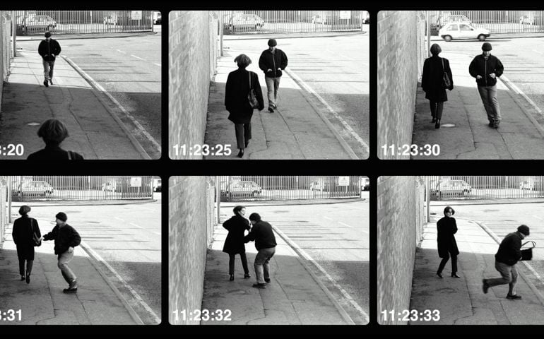 Man mugging woman in street (video still, Digital Composite)