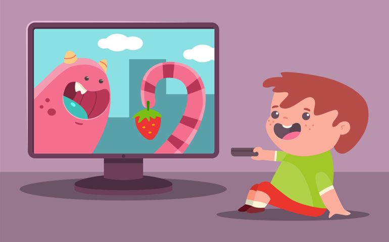 Little boy watches TV. Vector cartoon illustration of a child.
