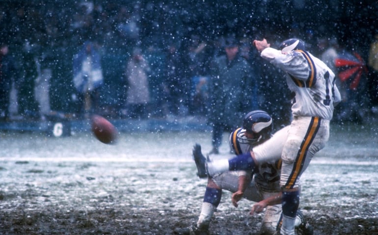 DETROIT, MI - NOVEMBER 27: Paul Krause #22 of the Minnesota Vikings holds the ball for kicker Fred Cox #14 during an NFL game against the Detroit Lions on November 27, 1969 at Tiger Stadium in Detroit, Minnesota.