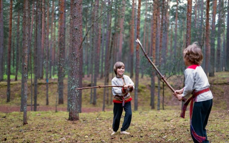 Children playing with wooden stick