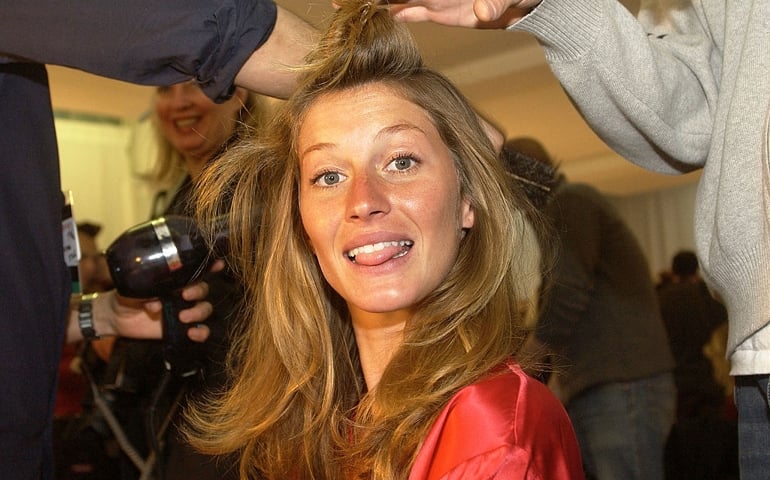 NEW YORK - NOVEMBER 14: Model Gisele Bundchen gets hair and makeup backstage at the Victoria Secret Fashion Show at the Lexington Avenue Armory November 14, 2002 in New York City.