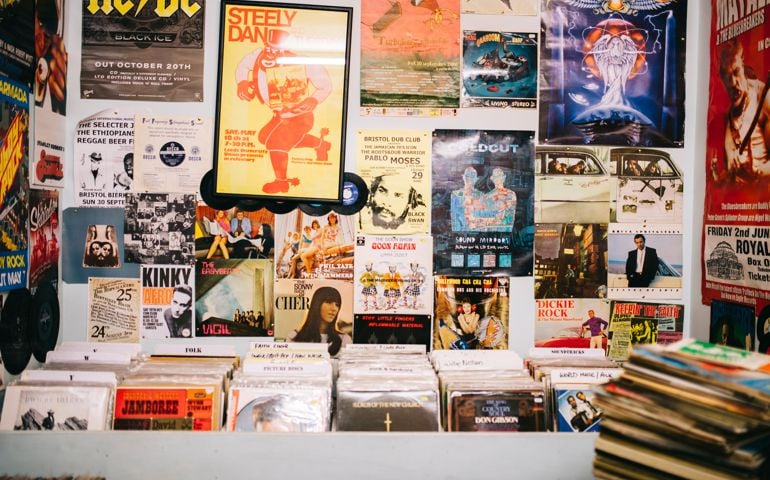Record Shop. Pop music posters, advertising bands, stuck on to the walls of a shop selling vinyl records.