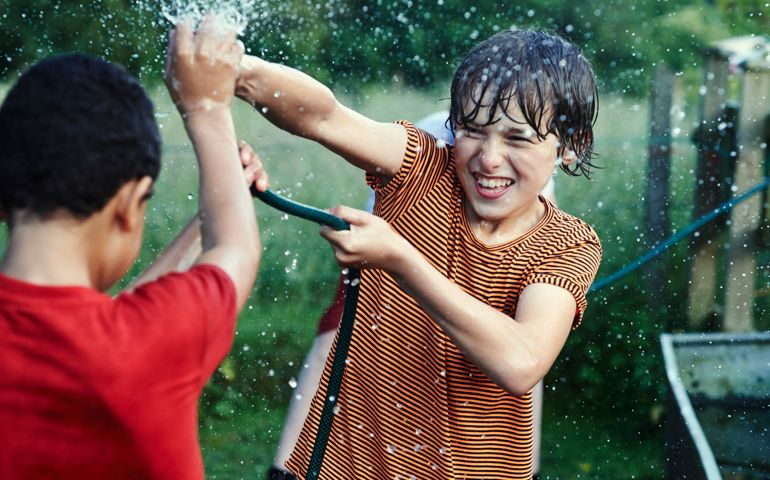 Group of friends playing with water