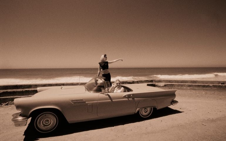 Driving Vintage Car on Beach