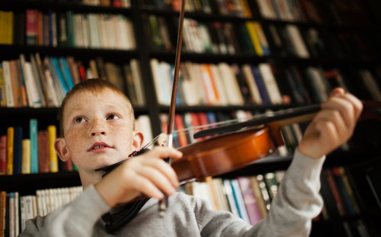 Boy (10-12) playing violin
