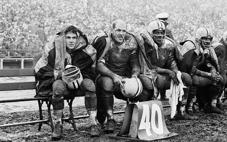 American professional football player Ray Nitschke (1936 - 1968) (second from left) of the Green Bay Packers sits on the bench with teammates during an away game against the 49ers, Kezar Stadium, San Francisco, December 10, 1960. The Packers won 13 - 0.