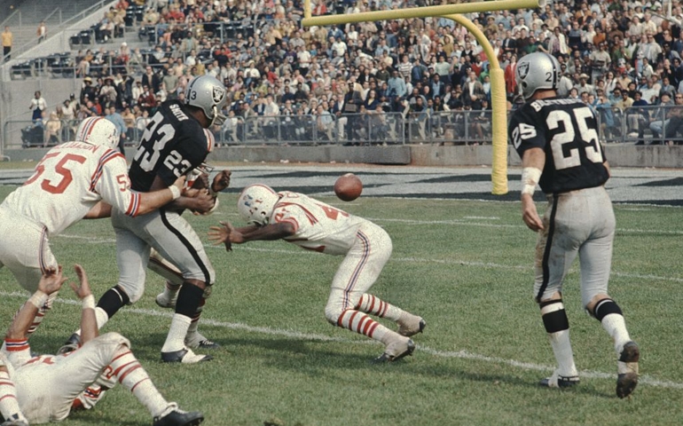 Charlie H Smith, Fred Biletnikoff, and football team during a National Football League game between the Oakland Raiders and the New England Patriots, 1975.