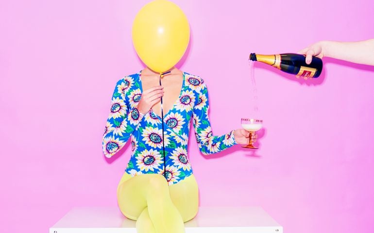 woman with balloon and champagne