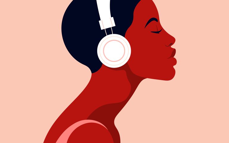 The girl listens to music on headphones