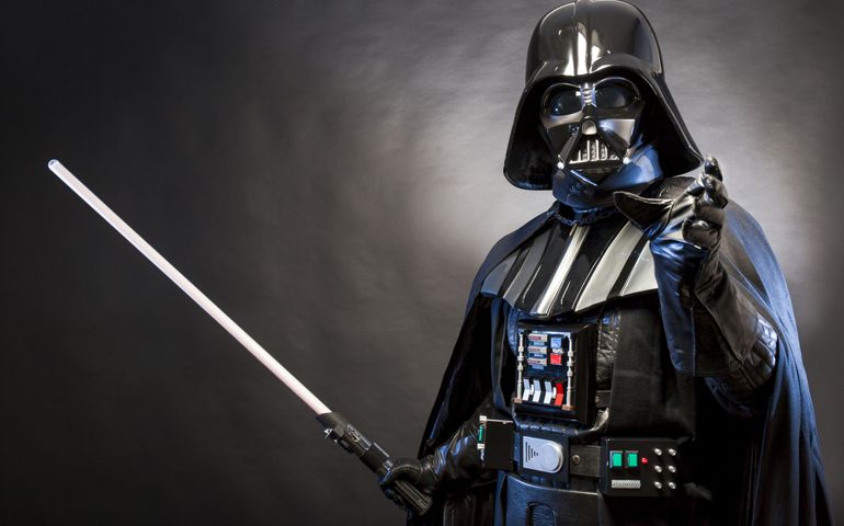 Portrait of Darth Vader costume replica with grab hand and sword