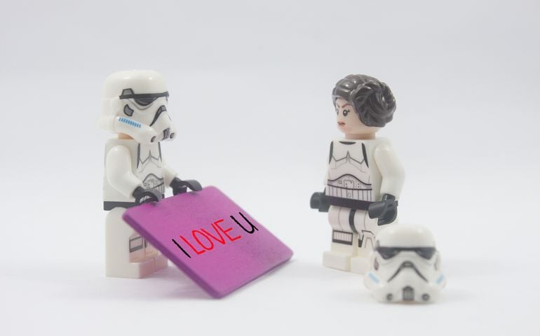 Lego star wars storm troopers with wooden tag written i love u and Princess Leia over white background