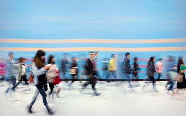 People passing blue wall (motion blurred) in Central District of Hong Kong at dawn. You can also find a similar version with a yellow wall within the EschCollection.