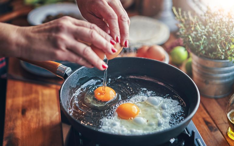 Frying Egg in a Cooking Pan in Domestic Kitchen