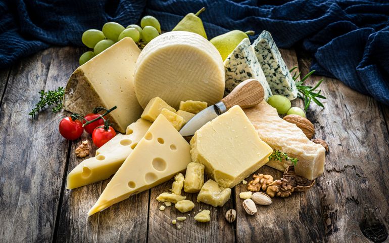 Cheeses selection on rustic wooden table
