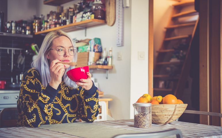 Woman eating breakfast at home.