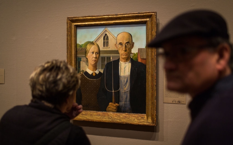CHICAGO, IL - JANUARY 15: Visitors to the Art Institute of Chicago view the painting "American Gothic" by Grant Wood January 15, 2014 in Chicago, Illinois.