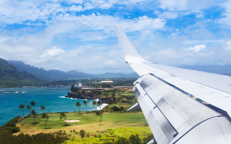 A plane flies into Lihue airport on Kauai.
