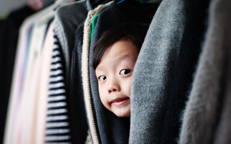 Child playing in the closet
