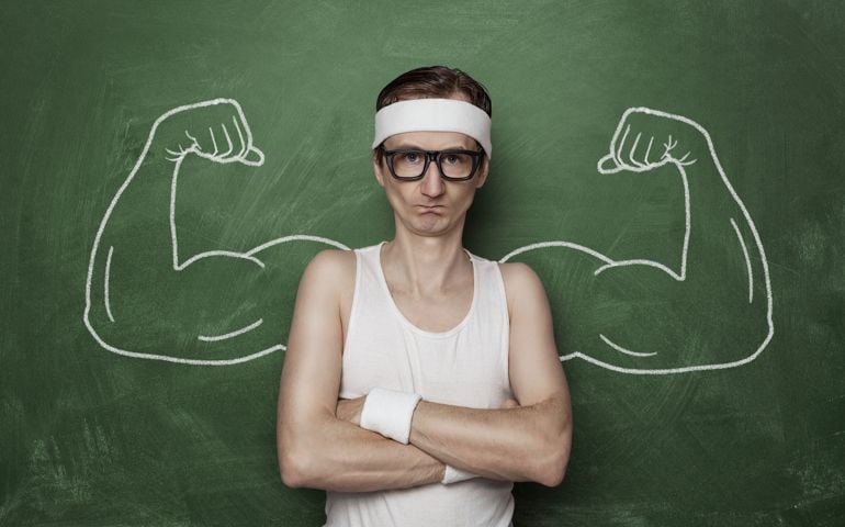 Funny sports nerd flexing fake muscle drawn on the chalkboard