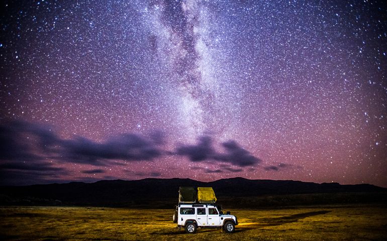 Sani Pass, Lesotho -car sets up camp for the evening beneath the stars.