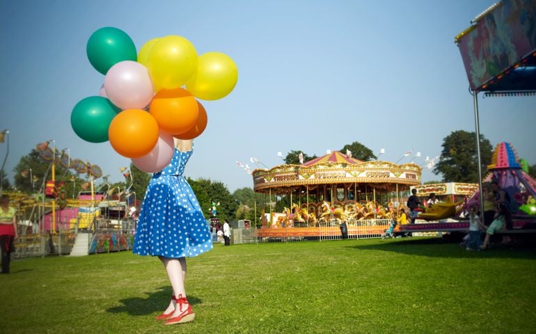 Woman with balloons at fair