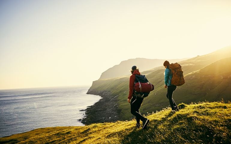Shot of a young couple hiking through the mountains