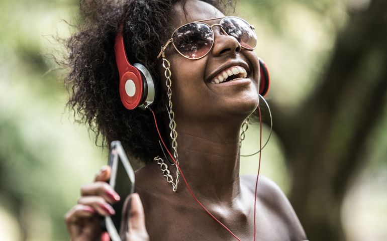 Woman Listening Music at Park