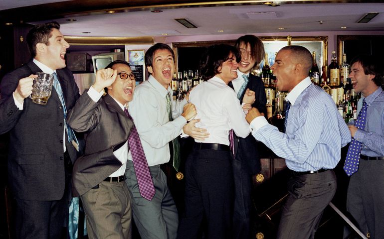 Businessmen at bar cheering