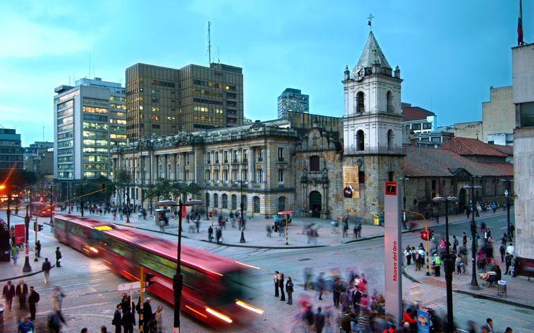 At the intersections of Avendia Jimenez and Carrera Septima, red Transmilenio buses pull into the Museum of Gold station in front of the16th century Iglesia de San Francisco, Bogota'soldest restored church.
