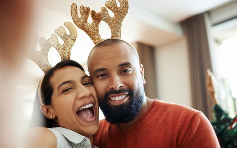 Shot of a happy young couple taking a selfie during the Christmas holidays at home